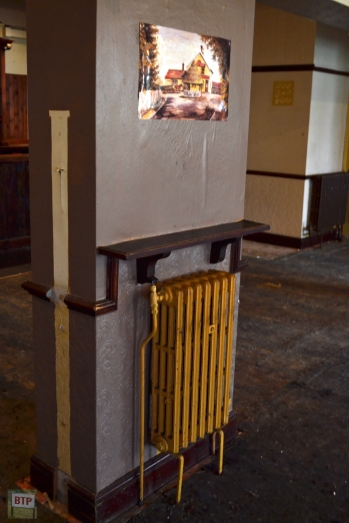 An old radiator with a photo/painting of the old building